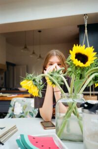 Girl in Kitchen with Sunflowers